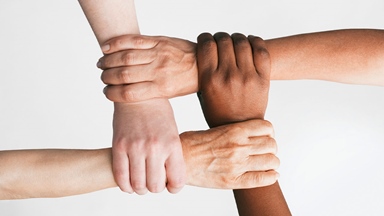 Four hands cross linked holding each other